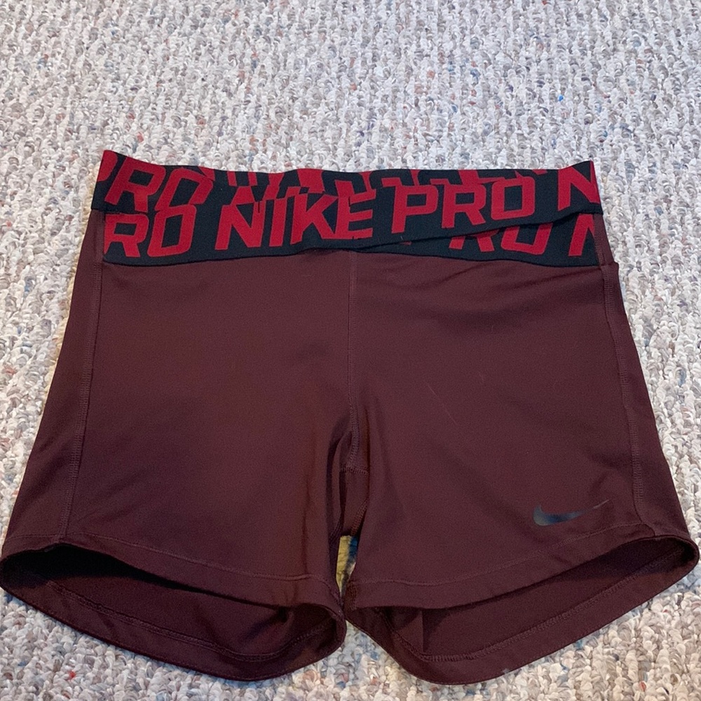 Red and black Nike Pros